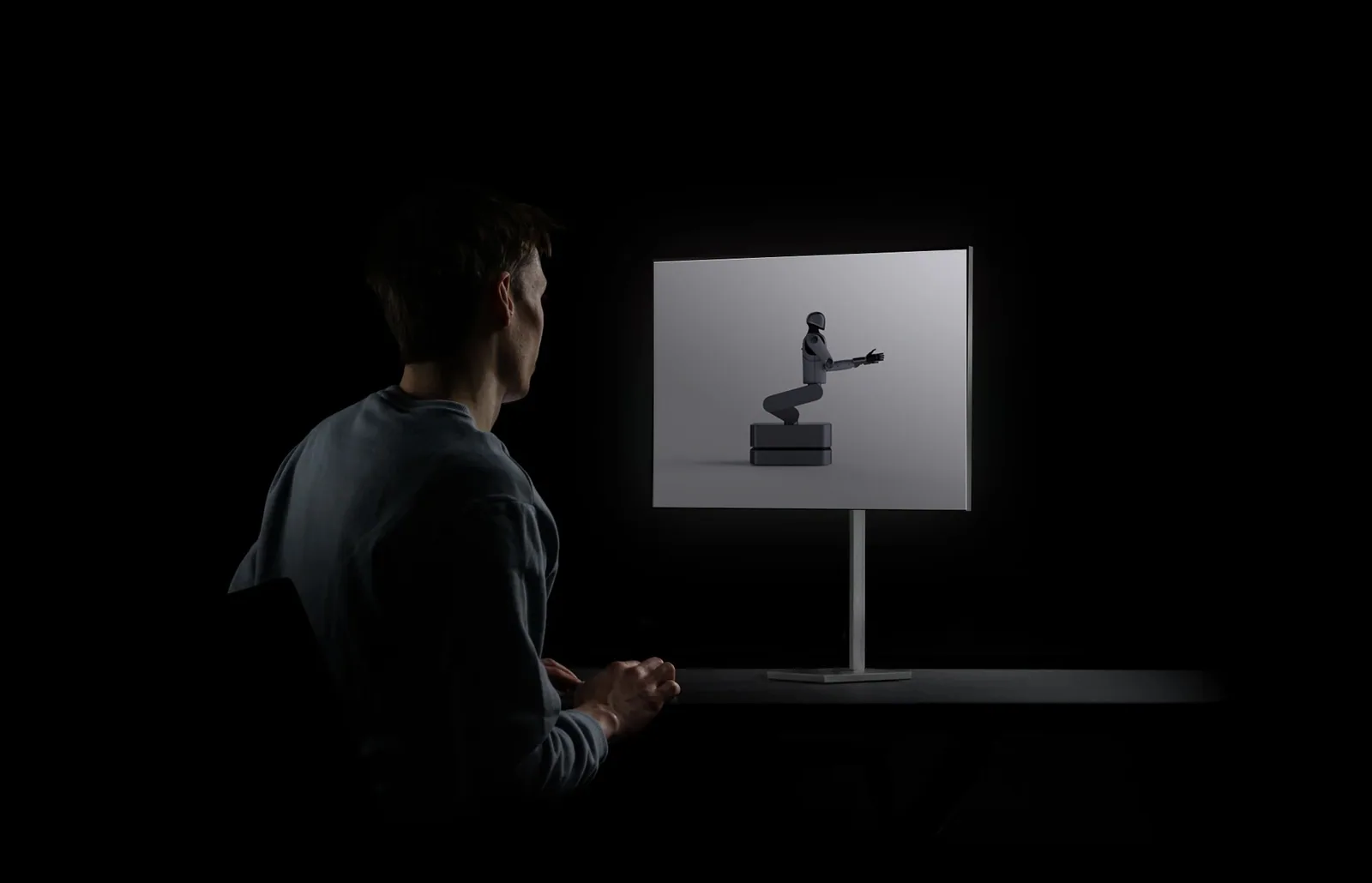 A person at a desk looking at a screen that shows MARK One